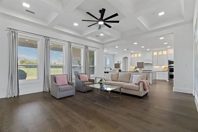 a living room with furniture and large windows