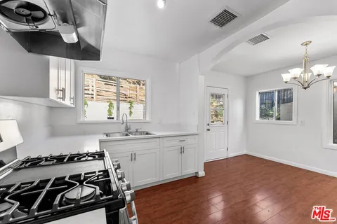 a kitchen with a stove a sink and a microwave