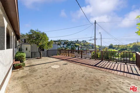 a view of a pathway with a wrought fence