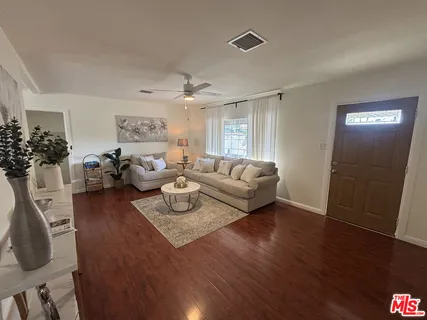 a living room with furniture and a large window