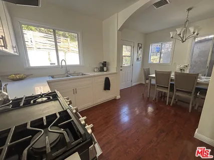 a kitchen with a table chairs and a window