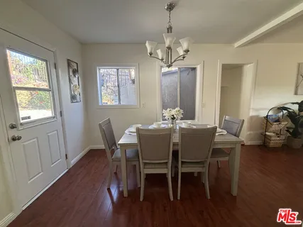 a view of a dining room with furniture wooden floor and chandelier