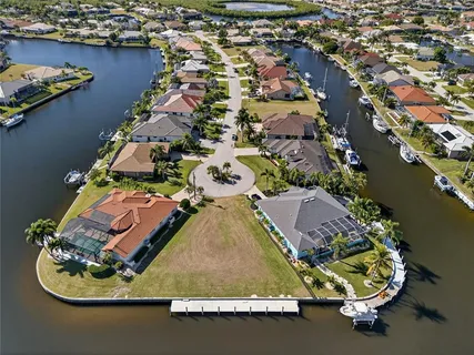 an aerial view of a house with a swimming pool and outdoor seating