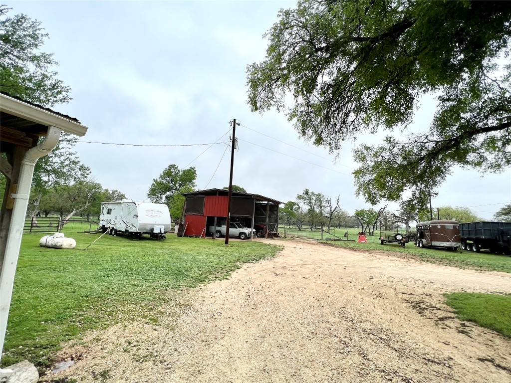 2700 County Road 305 Jarrell, TX 76537 - Photo 20 of 33 a view of a yard with a table and chairs under an umbrella