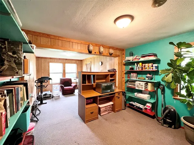 a bedroom with furniture and a book shelf