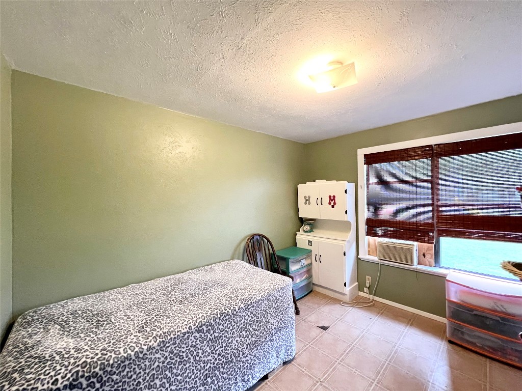 2700 County Road 305 Jarrell, TX 76537 - Photo 7 of 33 a bedroom with a bed and a large window