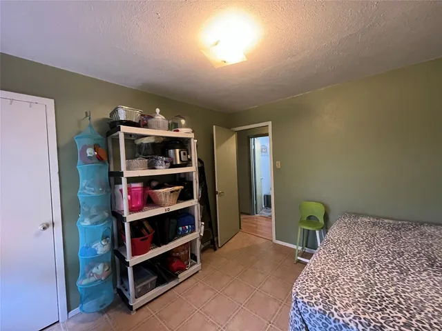 a bedroom with a bed and a book shelf