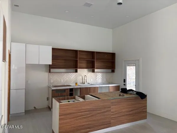 a room with a bed and cabinets