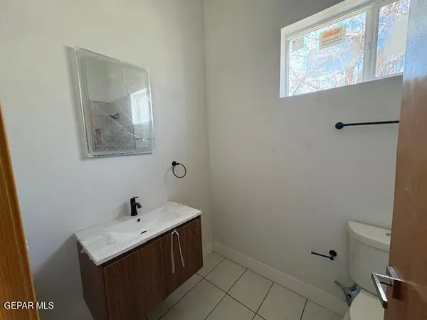 a bathroom with a sink toilet and vanity