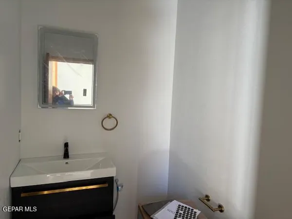 a bathroom with a sink a toilet and mirror
