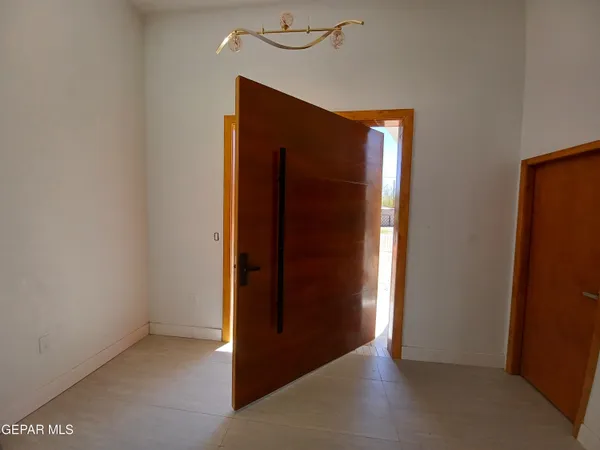 an empty room with closet and wooden floor