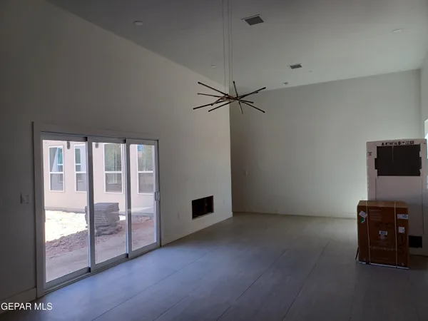 a view of a room with wooden floor and windows