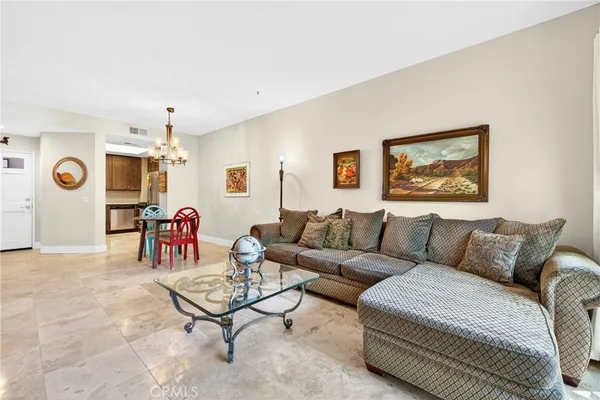 a living room with furniture and kitchen view