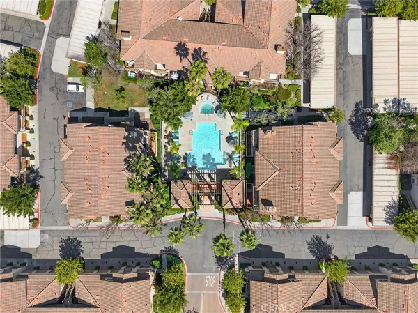 an aerial view of a residential houses with yard and ocean view
