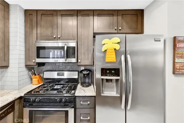 a kitchen with a stove and a refrigerator