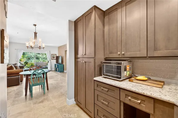 a kitchen with stainless steel appliances granite countertop a refrigerator and cabinets
