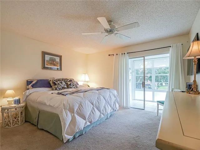 a bedroom with a large bed and a large window