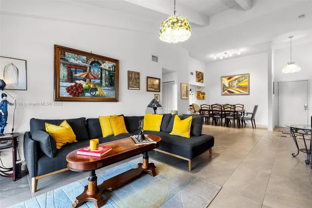 a living room with furniture piano and a chandelier