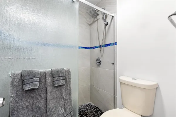 a bathroom with a toilet and a shower