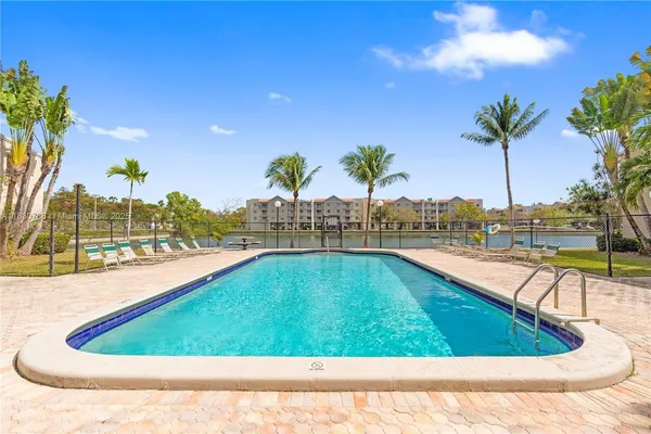 an aerial view of a house with a swimming pool and outdoor seating