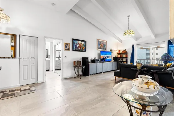 a living room with furniture and a dining table