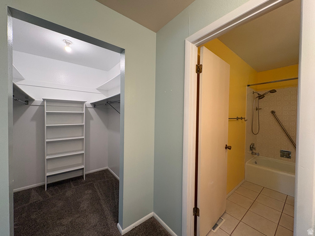 595 Meadowlark Road Orem, UT 84097 - Photo 28 of 87 Walk-in closet with built-in shelving, hanging rods, and carpet flooring