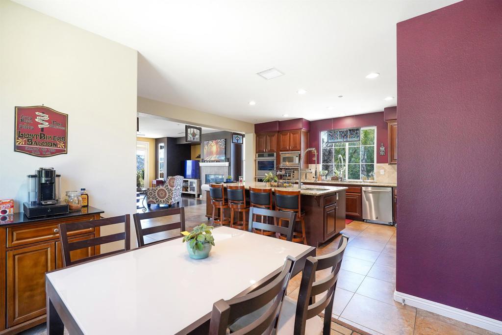22963 Stokes Road Ramona, CA 92065 - Photo 27 of 57 a view of a dining room with furniture and a kitchen
