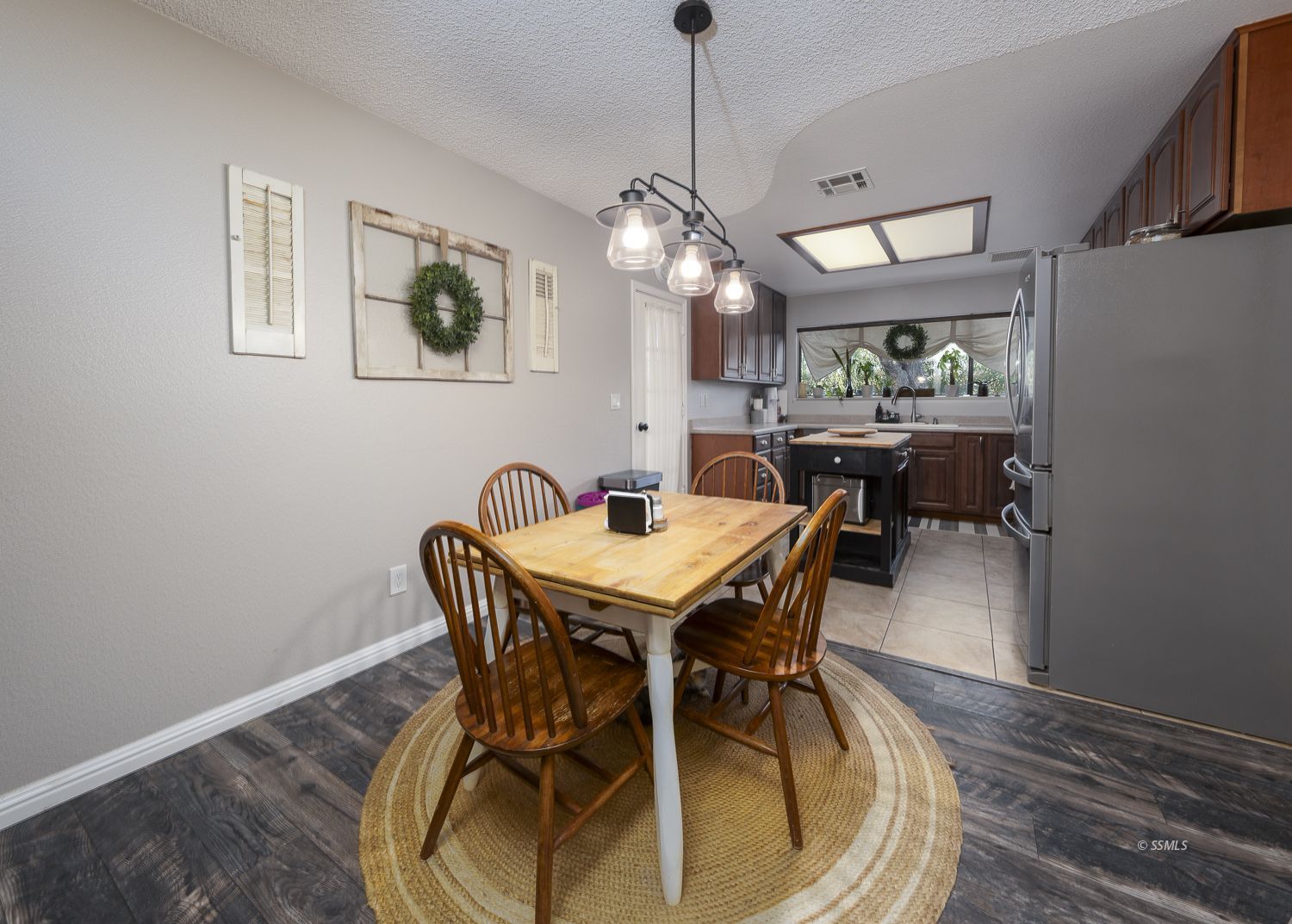 436 South Lincoln Street Ridgecrest, CA 93555 - Photo 7 of 34 a dining room with furniture a chandelier and wooden floor