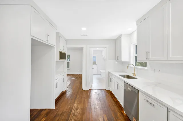 a kitchen with a sink stove and cabinets