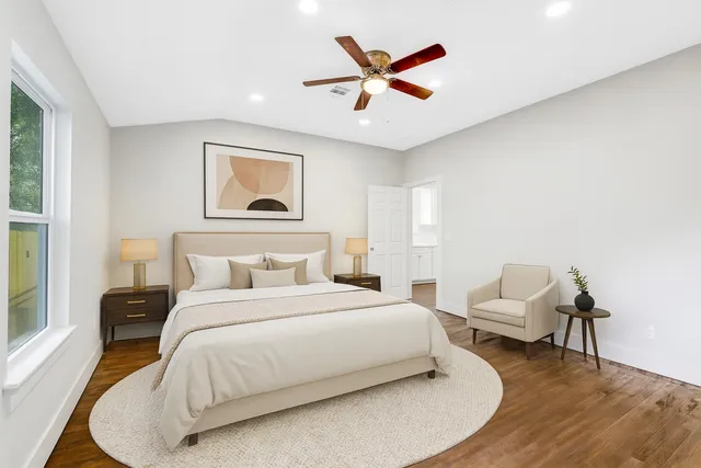 a bedroom with a bed and a painting on the wall