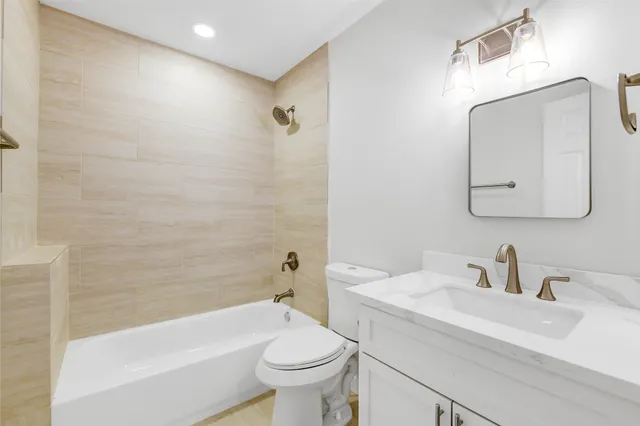an empty room with wooden floor and ceiling fan