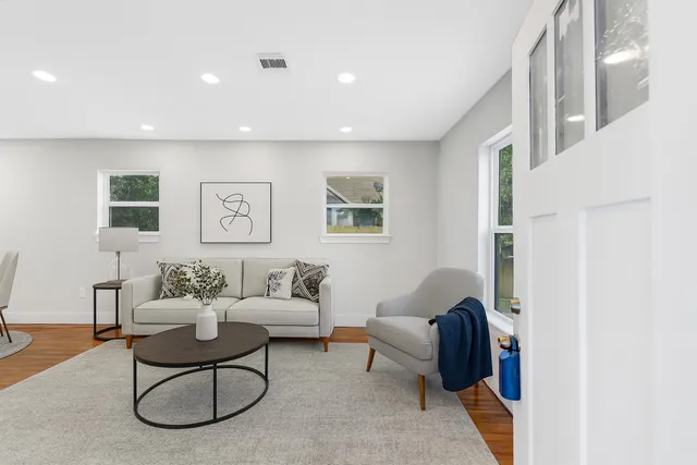 a view of a brick house with wooden fence