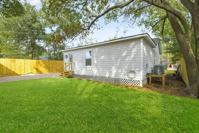 a view of a backyard with a large tree