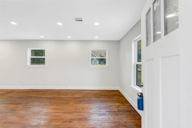 a living room with furniture a rug and a mirror