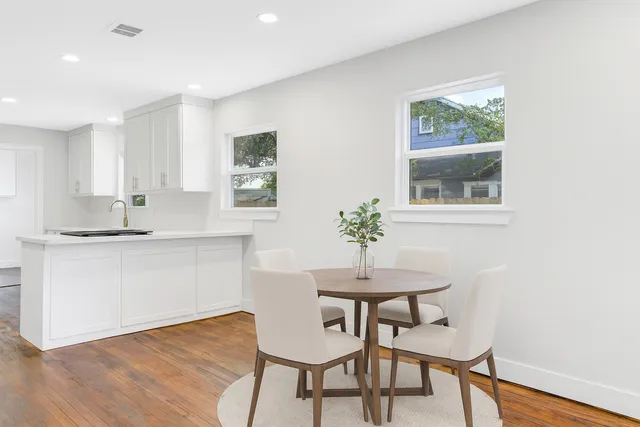 a view of a kitchen with wooden floor and a kitchen
