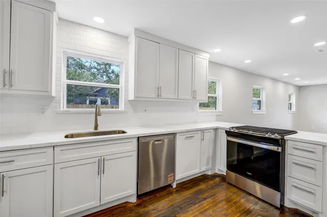 a kitchen that has a sink and a stove