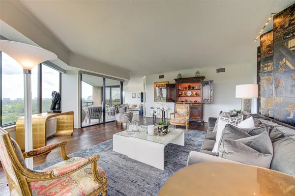 a living room with furniture and a floor to ceiling window