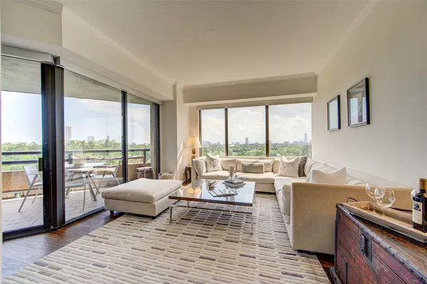 a living room with furniture and large windows