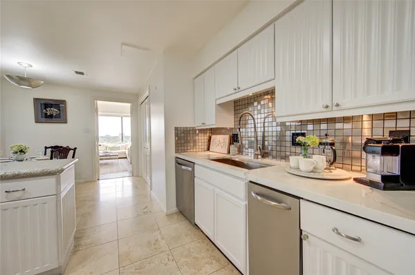 a kitchen with a sink and cabinets