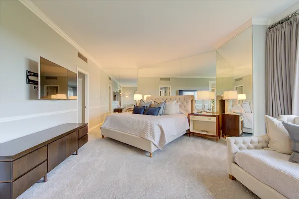 a bedroom with a large bed and a couch