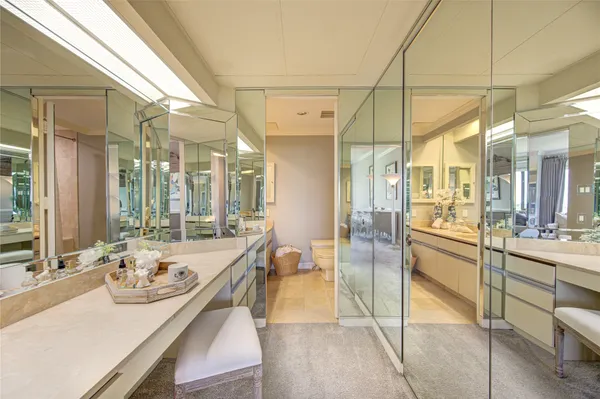 a bathroom with a granite countertop sink mirror and a bath tub