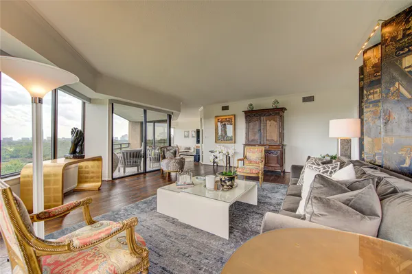 a living room with furniture and a floor to ceiling window