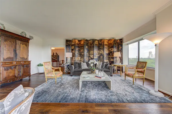 a living room with furniture rug and wooden floor