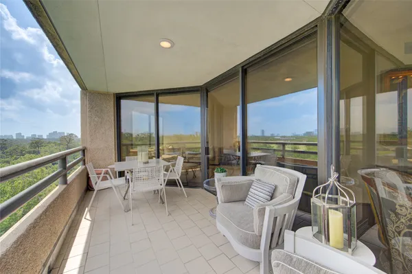 a living room with furniture city view and large windows