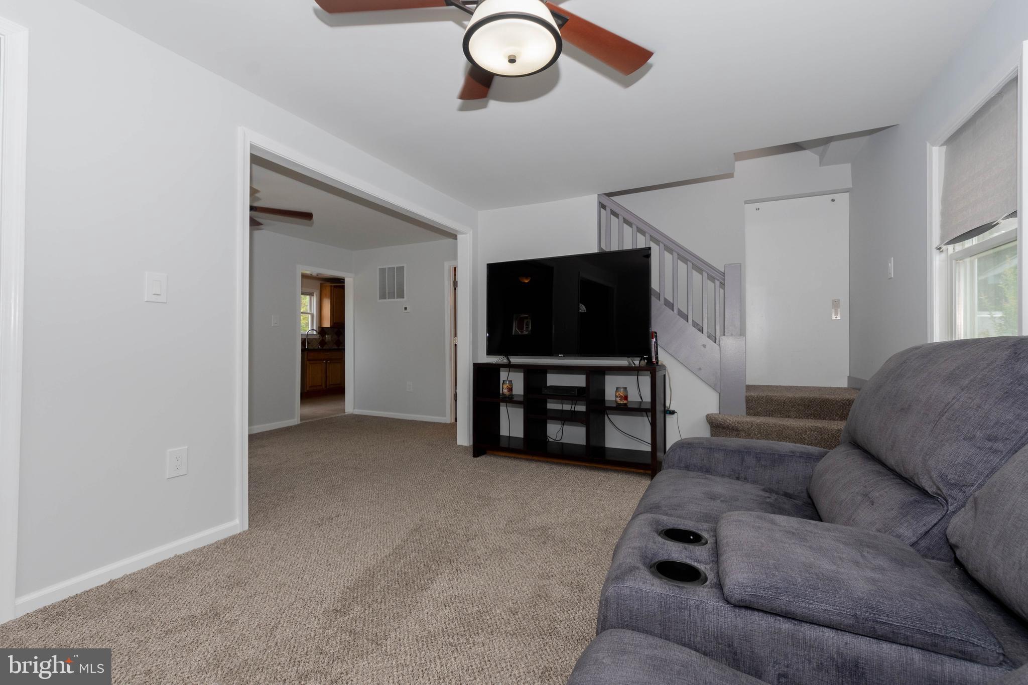 6414 Kenwood Avenue Rosedale, MD 21237 - Photo 11 of 60 a living room with furniture and a flat screen tv