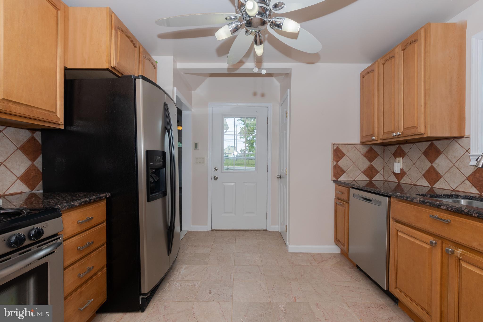 6414 Kenwood Avenue Rosedale, MD 21237 - Photo 14 of 60 a kitchen with stainless steel appliances granite countertop a refrigerator and a stove