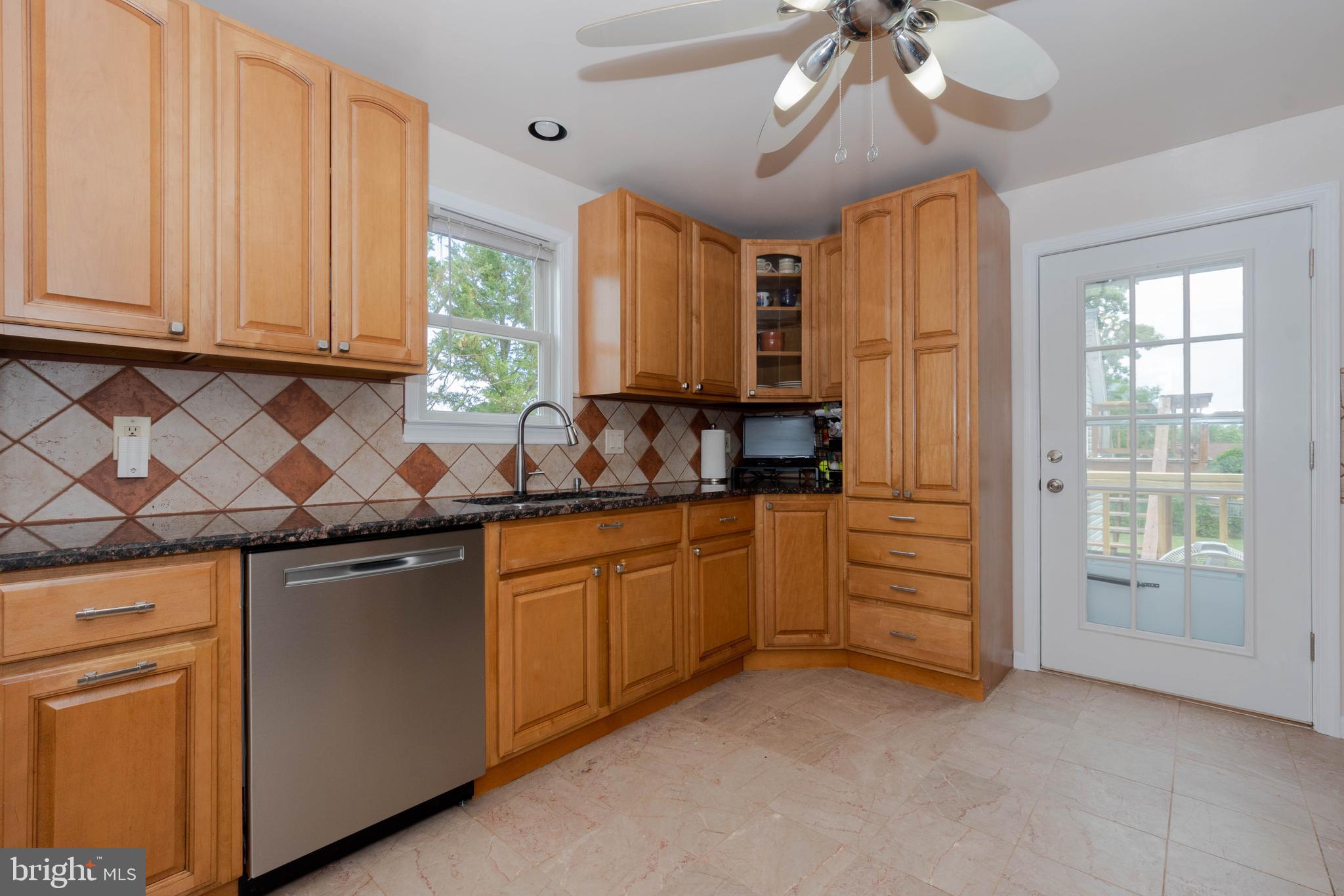 6414 Kenwood Avenue Rosedale, MD 21237 - Photo 18 of 60 a kitchen with granite countertop a sink stainless steel appliances and cabinets