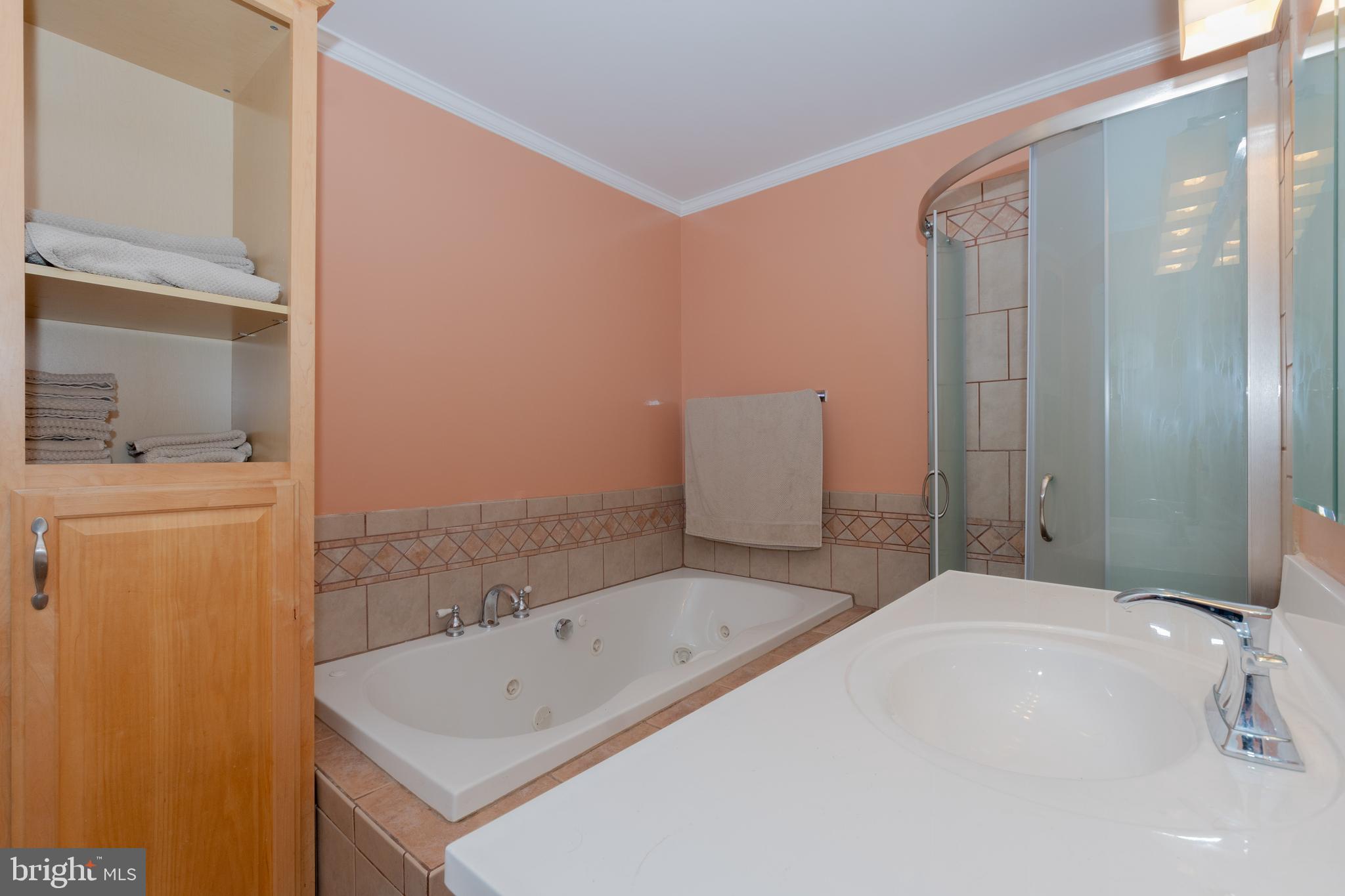 6414 Kenwood Avenue Rosedale, MD 21237 - Photo 22 of 60 a bathroom with a bathtub sink and mirror
