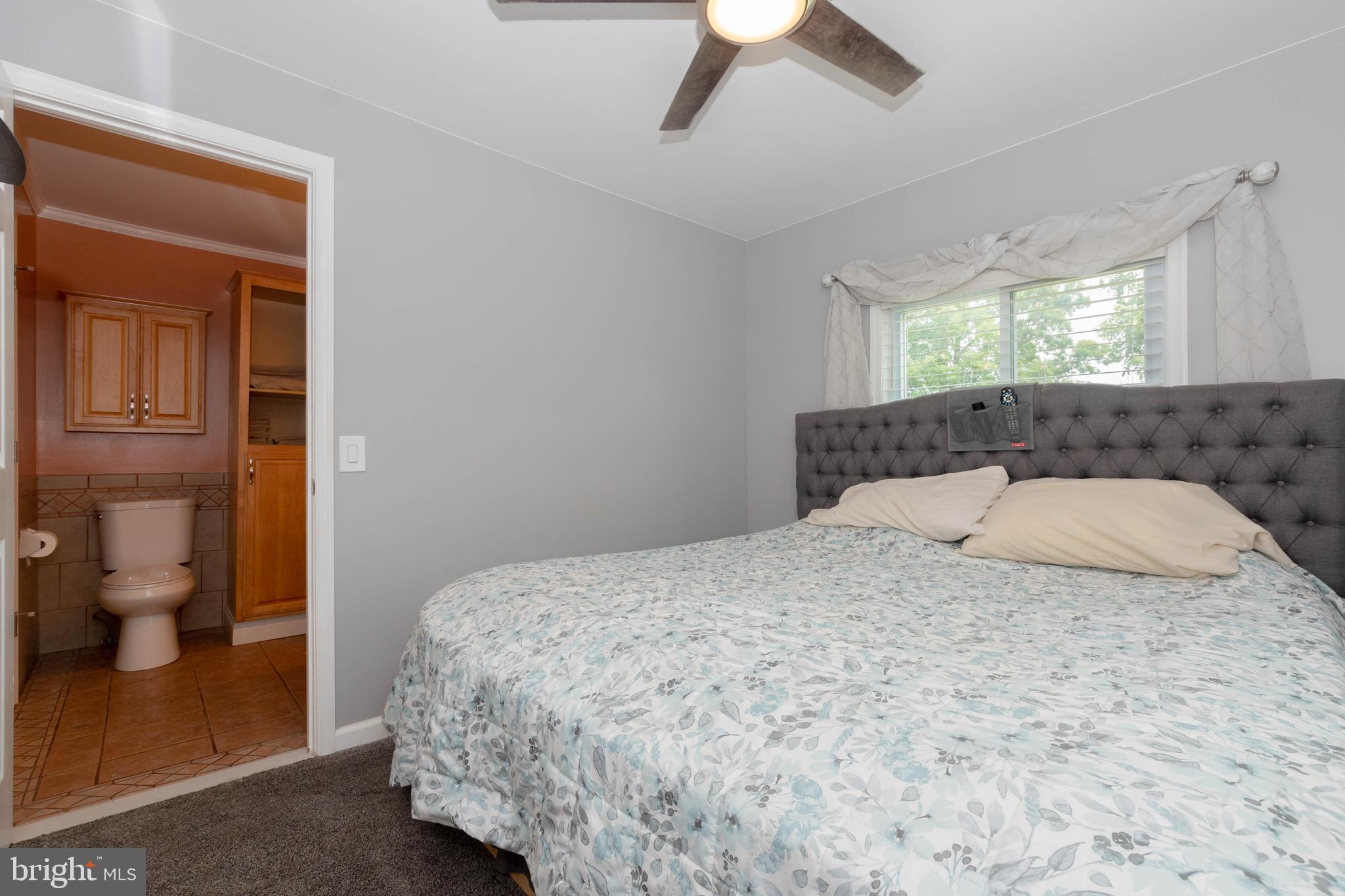 6414 Kenwood Avenue Rosedale, MD 21237 - Photo 27 of 60 a bedroom with a large bed and a window
