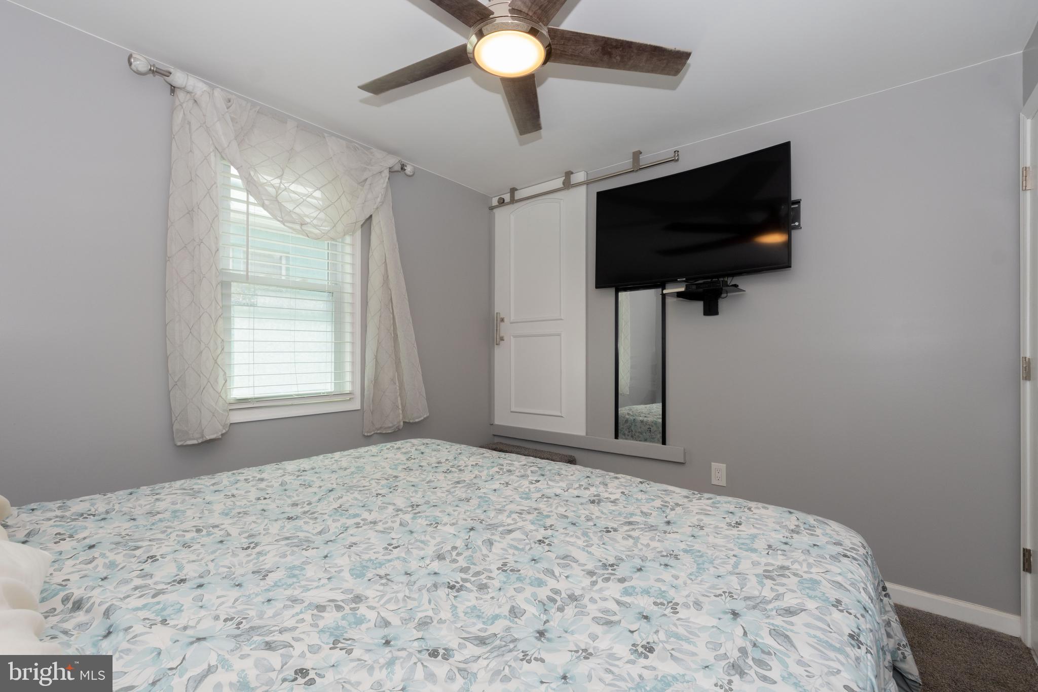 6414 Kenwood Avenue Rosedale, MD 21237 - Photo 28 of 60 a bedroom with a bed and a flat screen tv